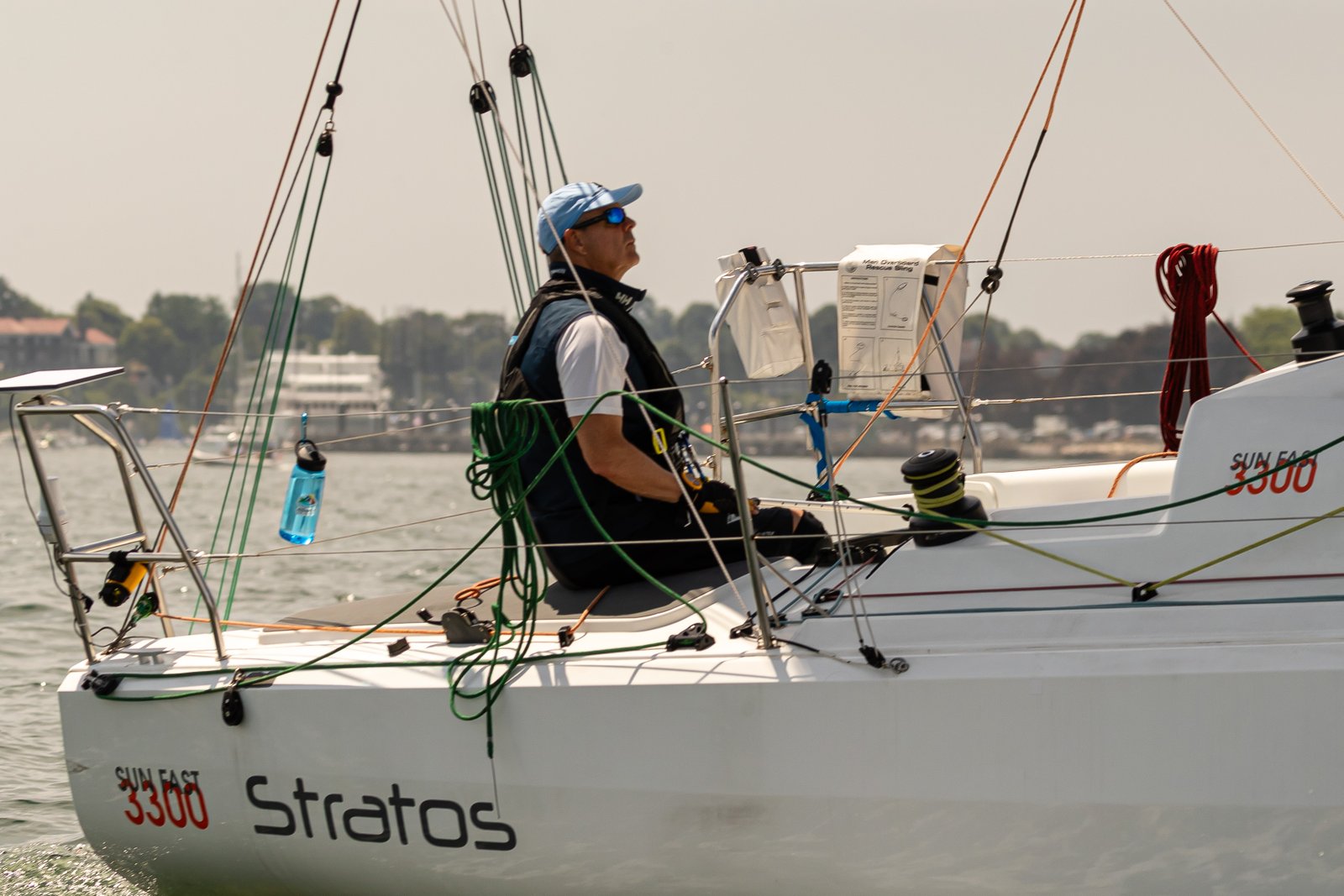 Marcus at the helm, pre-start — race documents on the companionway