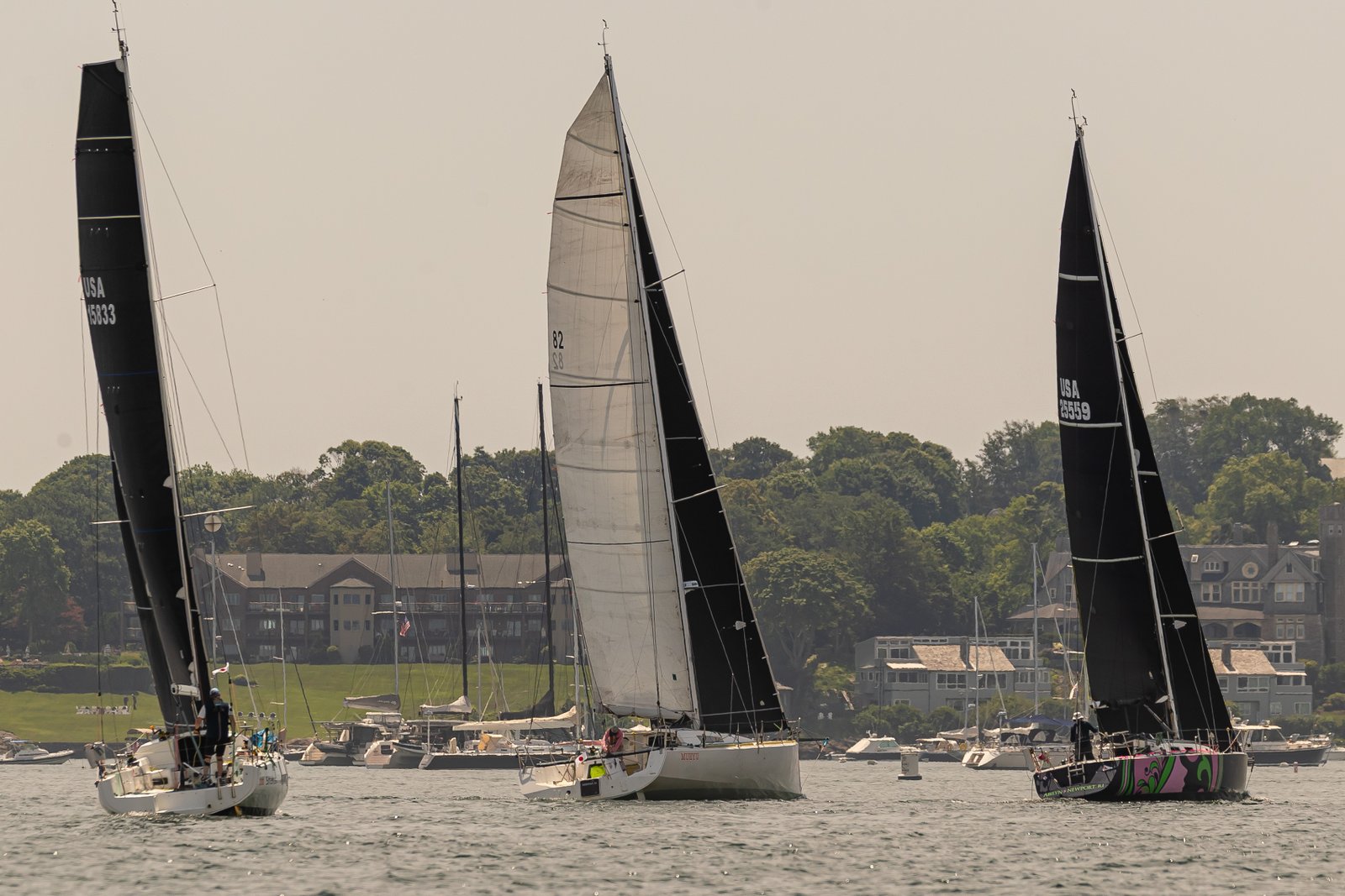 Fleet spread across Newport Harbor — three boats abreast